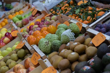 Sets of different fruits displayed on the counter of a greengrocer's shop