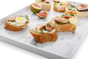 Tasty sandwiches with fig on white background