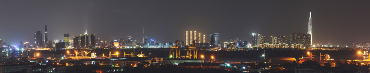 Fototapeta na wymiar Aerial panoramic cityscape view of Ho Chi Minh city and the River Saigon, Vietnam with beautiful lights at night. Financial and business centers in developed Vietnam