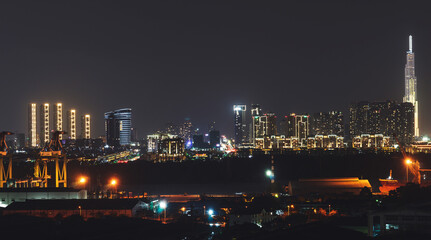Fototapeta na wymiar Aerial panoramic cityscape view of Ho Chi Minh city and the River Saigon, Vietnam with beautiful lights at night. Financial and business centers in developed Vietnam