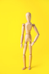 Wooden mannequin on color background