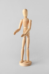Wooden mannequin on light background