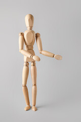 Wooden mannequin on light background