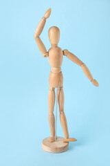 Wooden mannequin on color background