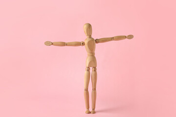 Wooden mannequin on color background
