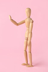 Wooden mannequin on color background