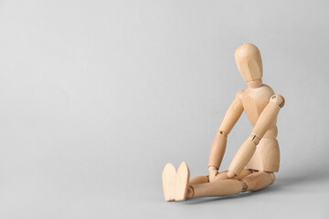 Wooden mannequin on light background