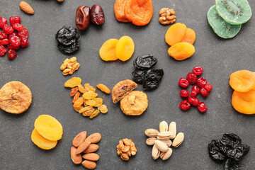 Different dried fruits and nuts on dark background