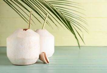 Fresh coconuts on color wooden background