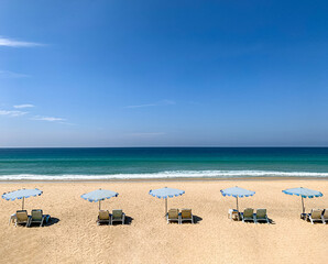 Beach beds at clear empty beach