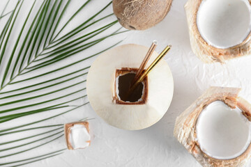 Fresh and ripe coconuts on light background