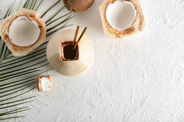 Fresh and ripe coconuts on light background