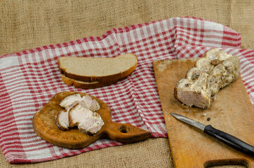 Traditional Ukrainian dish. Baked pork belly, rye bread, wooden cutting board, knife.