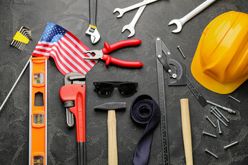 Set of tools and USA flag on dark background. Labor Day celebration