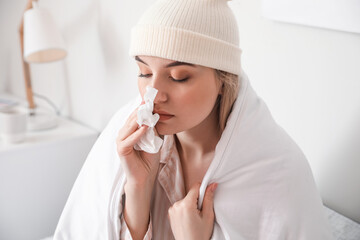 Sick young woman at home