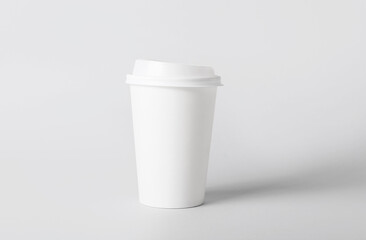 Blank takeaway cup on light background