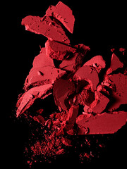 Fototapeta na wymiar Crushed red eye shadow isolated on black background