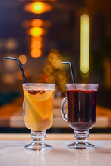 Closeup of mulled wine, two glasses of different kind of mulled white. Blurred background, Christmas time.
