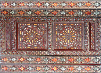 Detail of wooden wall panel with floral carving and painting ornament, Morocco