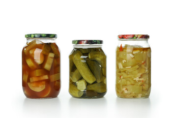 Jars with different pickled food isolated on white background