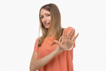 Displeased blond woman shows hands in stop or no gesture, denies problems, ignores something or...