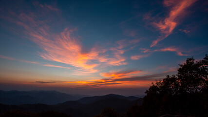 The mountains are high  the sunlight shines  the color of the sky is beautiful.