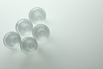 Shots of vodka or tequila on white background