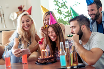 Young woman celebrating birthday at home