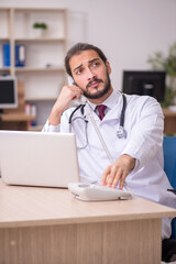 Fototapeta premium Young male doctor in telemedicine concept