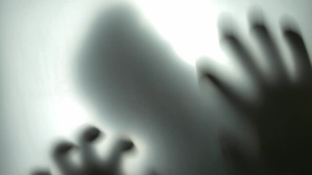 Silhouette of Scary Man Behind Translucent Glass Scratching the Surface