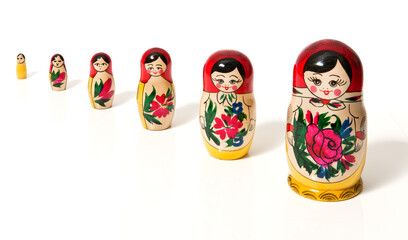 A growing row of Matrjoschka on white background