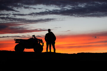 Fototapeta na wymiar Silhouette ATV or Quad bike in the sunset. Holiday exploration concept