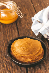 stack of pancakes on a wooden background