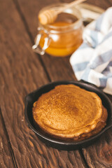 stack of pancakes on a wooden background