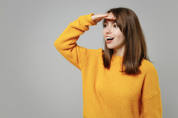 Young smiling positive optimistic cheerful attractive woman 20s wearing casual knitted yellow...
