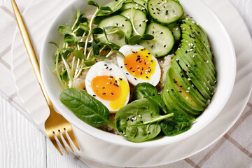 bowl with quinoa, greens, avocado and boiled egg