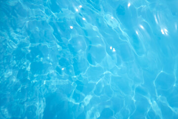 Surface of blue swimming pool. Background of blue ripped water in swimming pool