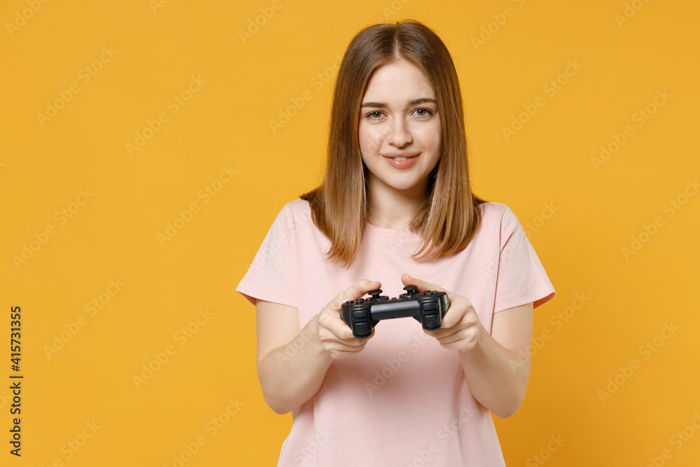 Wall mural young joyful caucasian student happy woman 20s wearing casual basic pastel pink t-shirt playing pc g