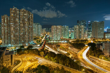 Fototapeta na wymiar Residential buildings and highway in Hong Kong at night