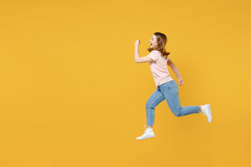 Fototapeta na wymiar Full length side profile view of young sportive energetic caucasian hurrying up woman 20s wearing basic pastel pink t-shirt jumping high run fast isolated on yellow color background studio portrait.
