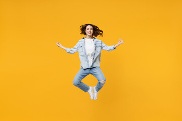 Full length of young fun happy spiritual woman 20s wear denim shirt white t-shirt hold hands in yoga gesture relax meditate try to calm down levitating isolated on yellow background studio portrait