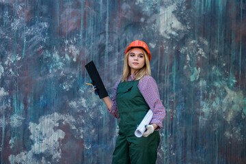 young woman in a special uniform plans to make repairs in the house