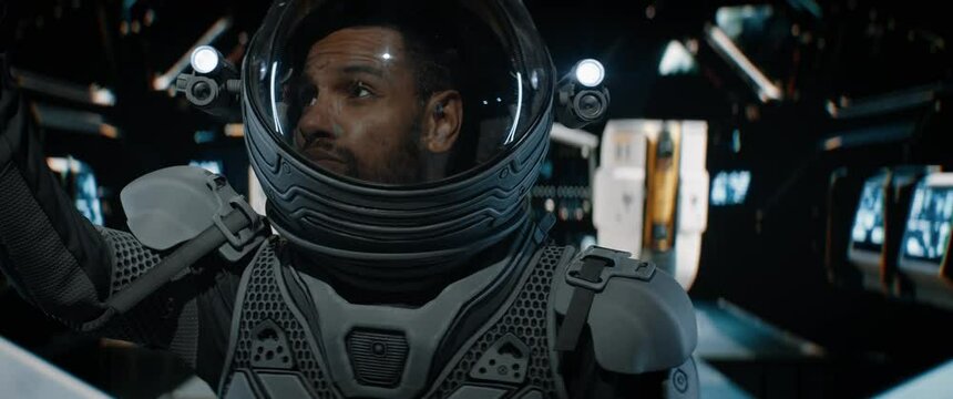 POV Black African American male astronaut having remote video call inside spaceship cockpit. Sci-fi space exploration concept. Shot with 2x Anamorphic lens