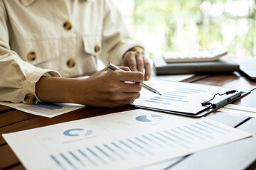 Company finance staff preparing financial documents, company finance staff preparing company...