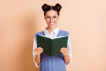 Photo of brunette optimistic lady read book wear spectacles white shirt blue vest isolated on beige color background