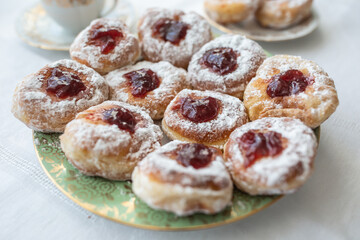 Obraz na płótnie Canvas A plate of donuts filled with jam and coated in sugar