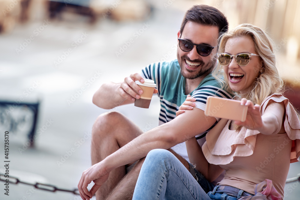 Sticker young couple taking selfie in the city