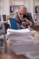 Old male employee unhappy with excessive work in the office