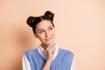 Photo of pretty thoughtful young girl dressed knitted waistcoat arm chin looking empty space isolated beige color background