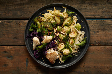 Tasty noodles with grilled cabbages on plate